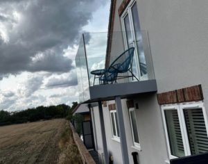 Freestanding Frameless Glass Balcony On House Close Up