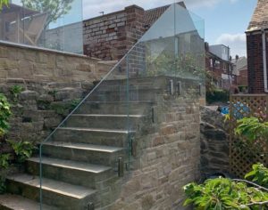 Steps And Frameless Glass Balustrade On Stone Steps