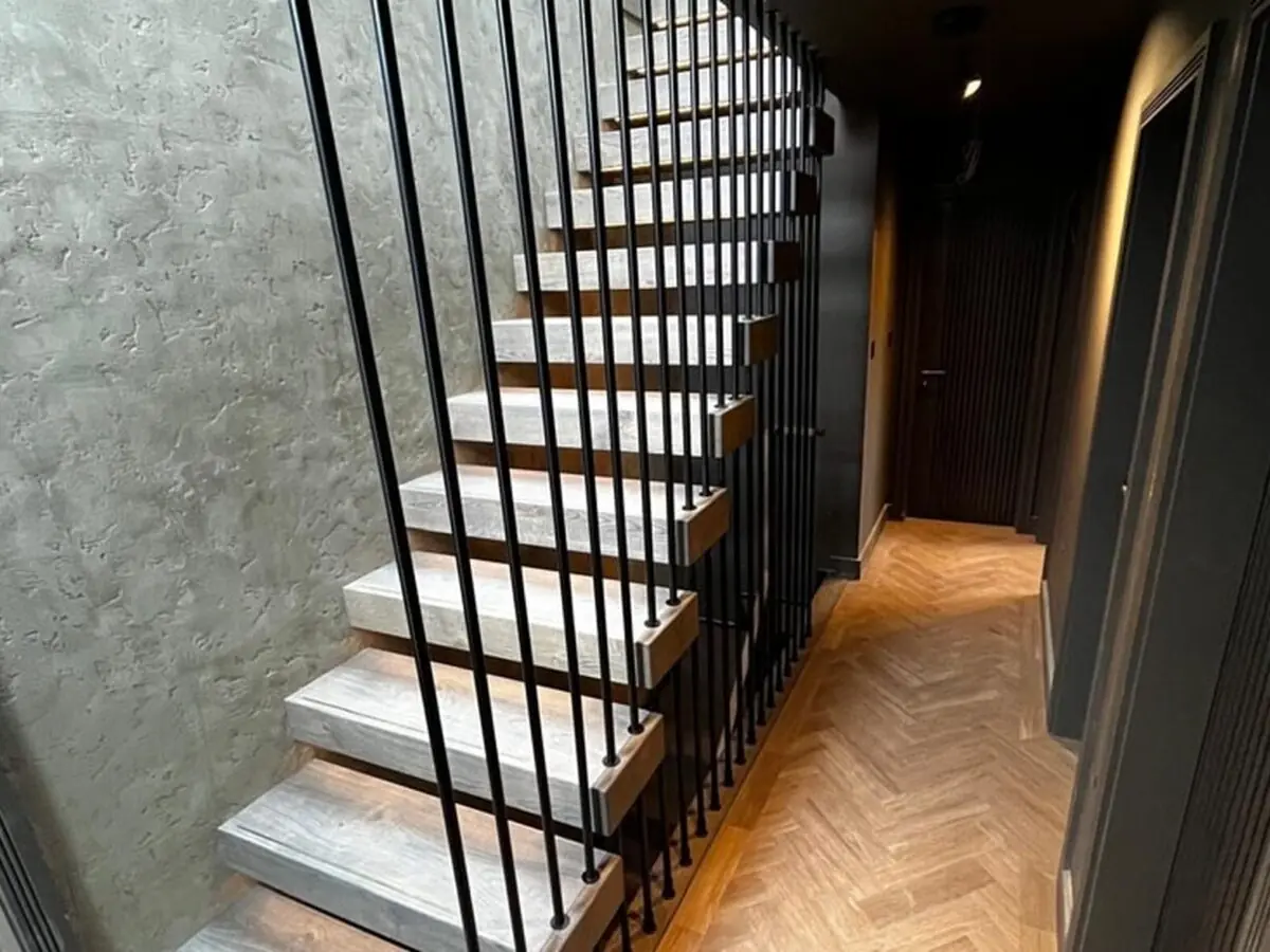 modern grey staircase with vertical full height metal rods