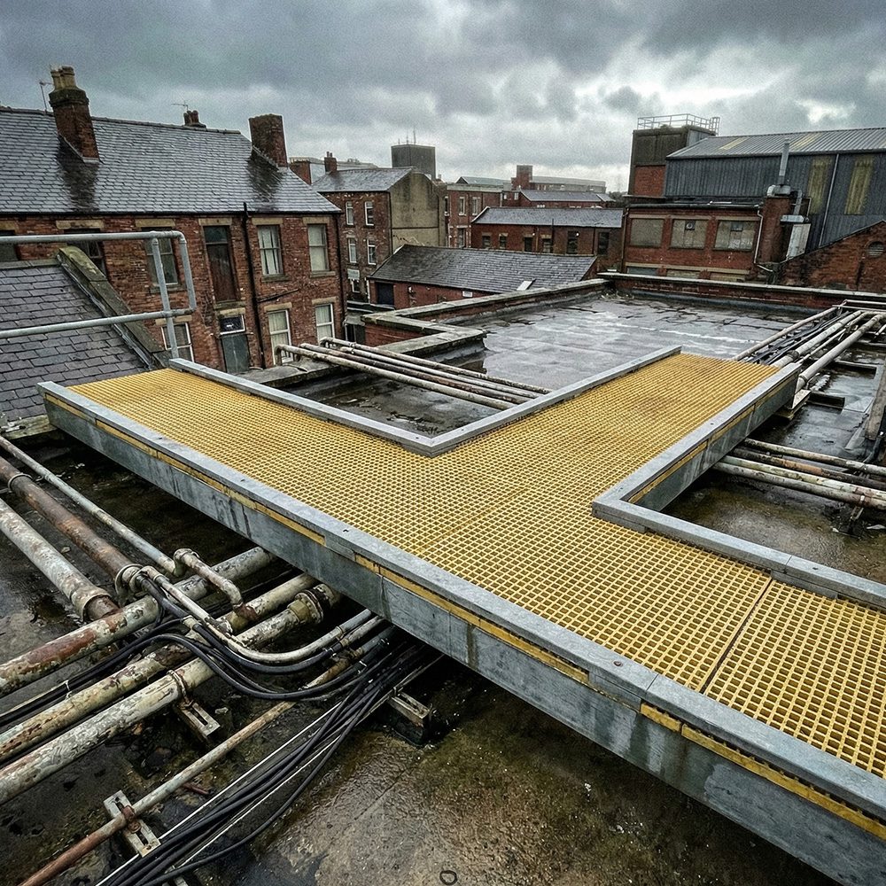Rooftop GRP access walkway mid-installation